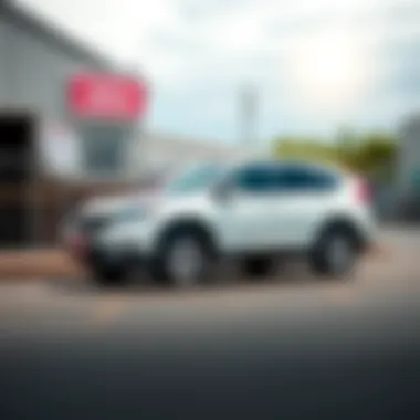 A 2014 Honda CRV parked outside an auction site, showcasing its clean exterior and shiny wheels, with a sign indicating it was sold for $2300.