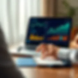 A person looking at a laptop showing investment graphs and charts, with a notebook and pen on the table.
