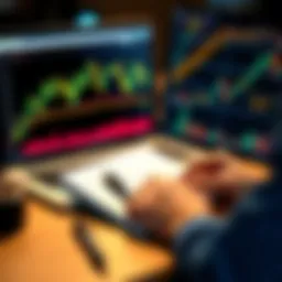 A person looking at Bitcoin charts on a laptop with a notebook and pen for notes
