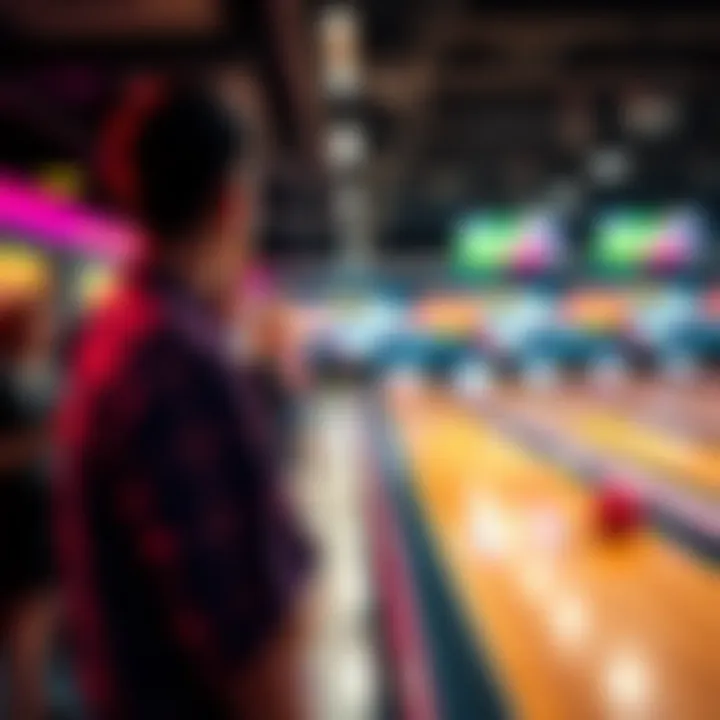 A bowler stands at the lane, concentrating intently as they prepare to roll the ball down the alley, while other players cheer nearby.