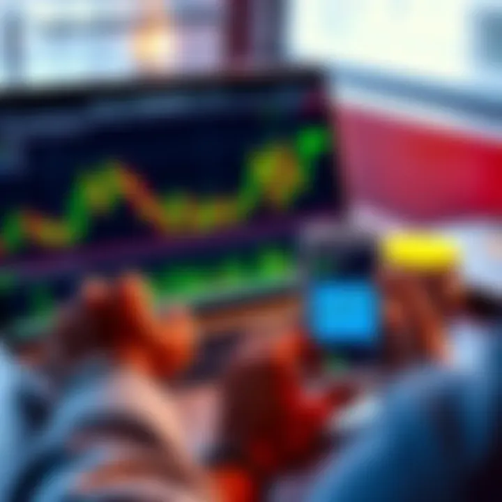 A person looking at a cryptocurrency chart on a laptop with green and red candlesticks, indicating fluctuating market prices, while holding a phone displaying a crypto wallet app.