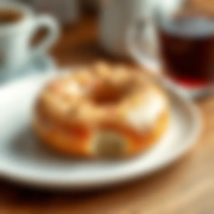 A close-up of a glazed donut on a white plate, showcasing its sprinkles and shiny glaze, with a warm cup of coffee in the background.