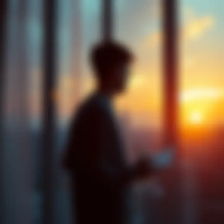 A person standing by a window with a view of a sunrise, studying or planning their day with a notebook and coffee in hand.