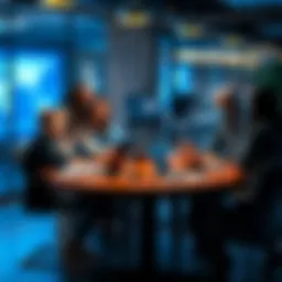 A group of people discussing cybersecurity concerns with laptops and notepads at a table