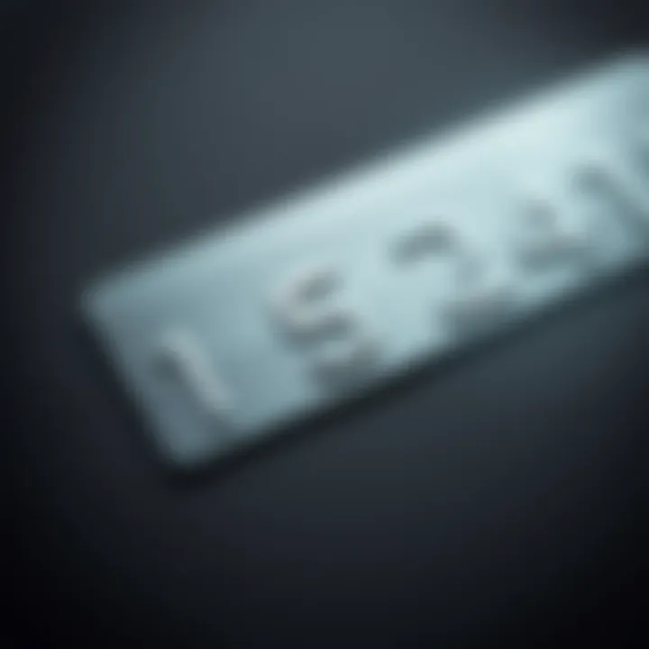 A close-up view of a metal card with indistinct numbers against a dark gray background, illustrating the visibility issue described in the article.