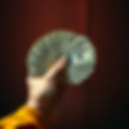 A person holding five hundred dollars, thinking about spending options due to Fed rate cuts.