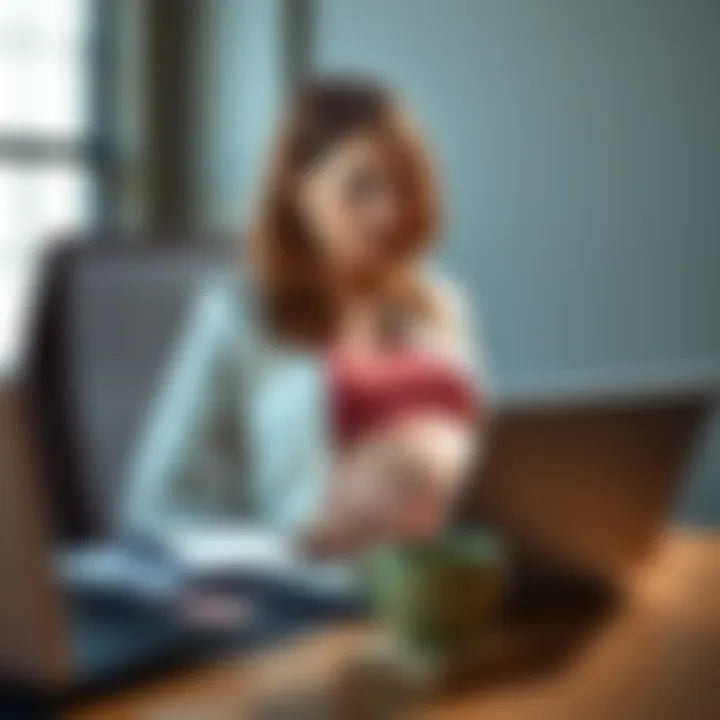 A pregnant woman sits at a desk with a laptop, looking thoughtful as she reviews a job offer with her hand on her belly.